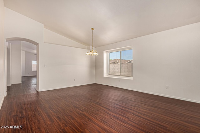 unfurnished room featuring arched walkways, lofted ceiling, a chandelier, and dark wood-type flooring