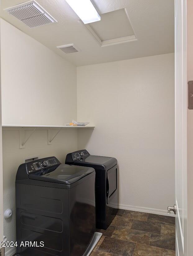 laundry area with washing machine and clothes dryer