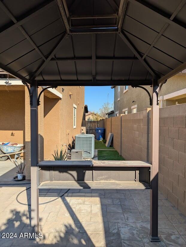 view of patio with cooling unit and a gazebo