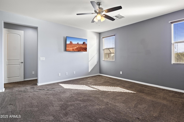 carpeted empty room featuring ceiling fan