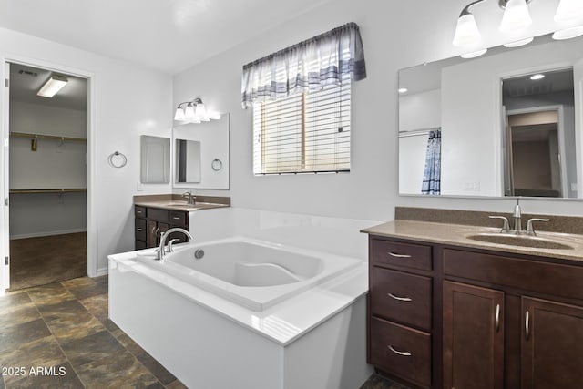 bathroom featuring vanity and a bath