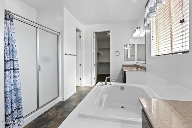 bathroom with vanity and separate shower and tub