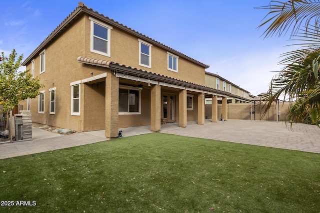 back of property featuring a yard and a patio