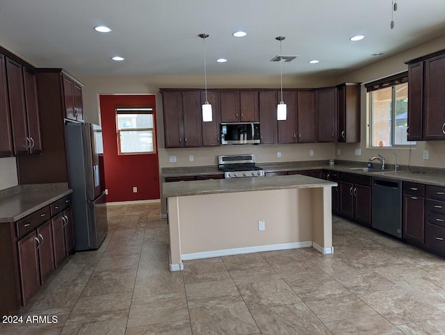 kitchen with sink, dark brown cabinets, a kitchen island, pendant lighting, and stainless steel appliances