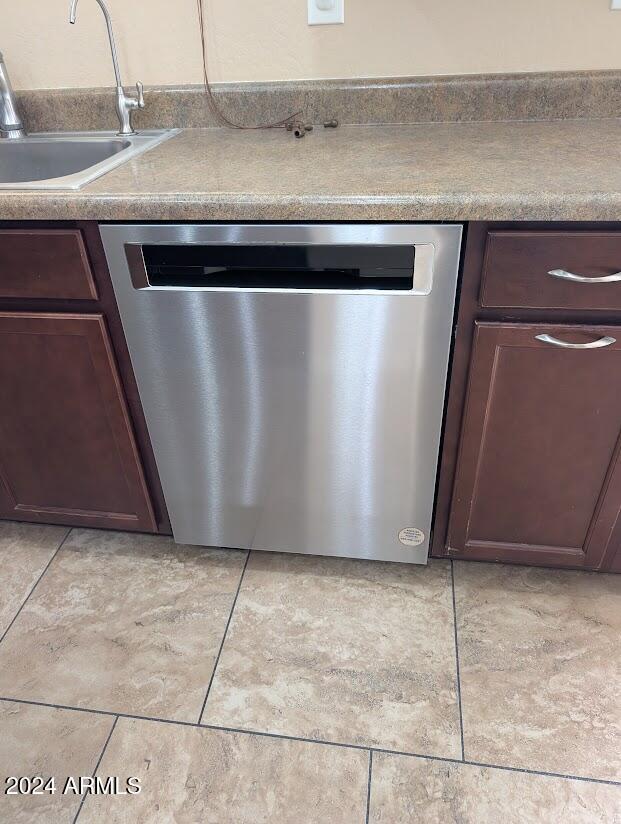 room details featuring sink, dark brown cabinets, and dishwasher