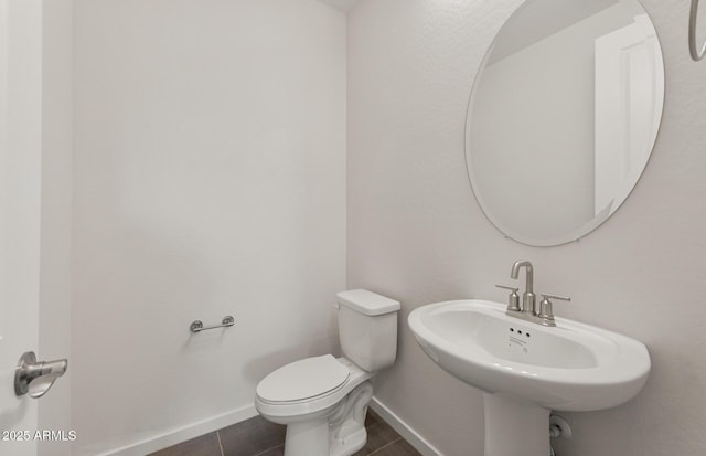 bathroom featuring tile patterned flooring, sink, and toilet