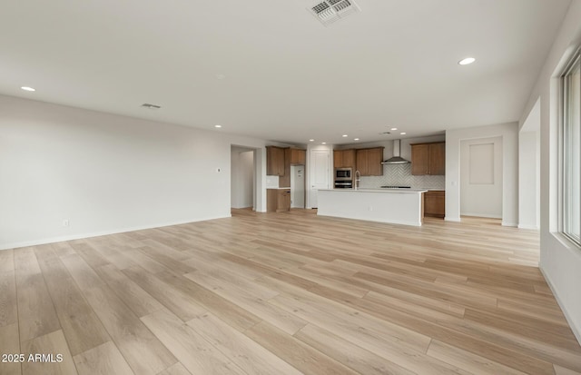 unfurnished living room with light wood-type flooring