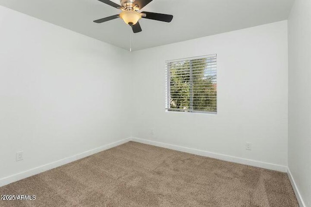 carpeted spare room featuring ceiling fan