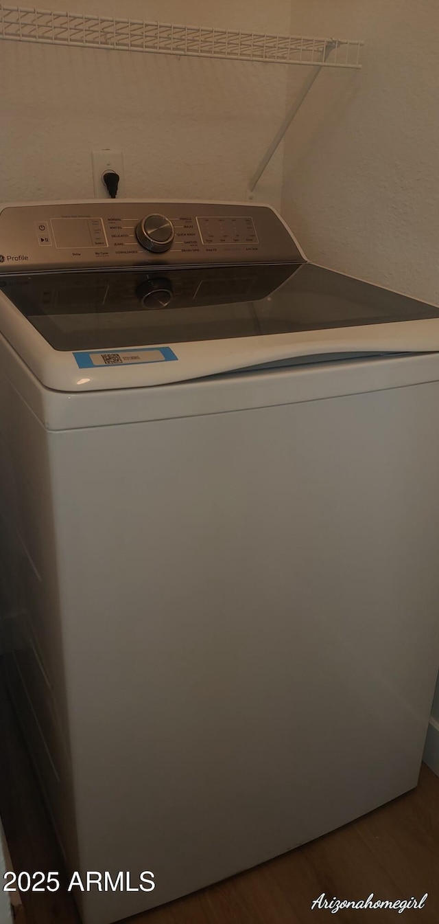 washroom featuring washer / dryer and wood-type flooring