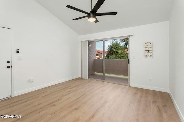 empty room featuring light hardwood / wood-style flooring, vaulted ceiling, and ceiling fan