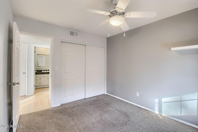 unfurnished bedroom with a ceiling fan, visible vents, baseboards, a closet, and carpet