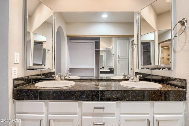 bathroom featuring double vanity and a sink