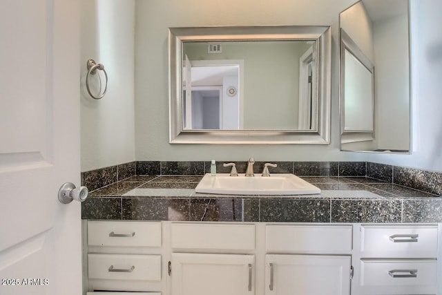 bathroom with visible vents and vanity