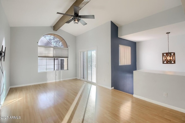 unfurnished room featuring lofted ceiling with beams, baseboards, wood finished floors, and ceiling fan with notable chandelier