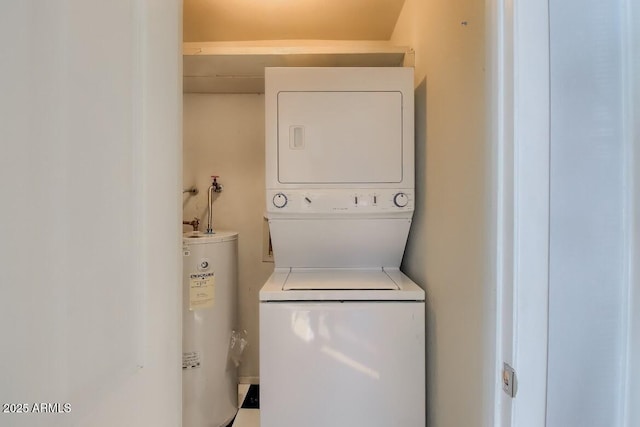 laundry area featuring laundry area, electric water heater, and stacked washing maching and dryer