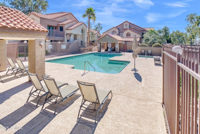 pool featuring fence and a patio