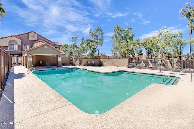 pool featuring a patio and fence