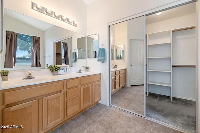 5153 W Topeka Dr, Glendale, AZ 85308 - bathroom featuring tile patterned floors, double vanity, a sink, and vaulted ceiling