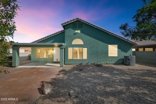 5153 W Topeka Dr, Glendale, AZ 85308 - rear view of house featuring a patio, stucco siding, central AC unit, a tiled roof, and fence