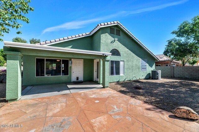 5153 W Topeka Dr, Glendale, AZ 85308 - rear view of house with central air condition unit, stucco siding, a patio area, a tiled roof, and fence