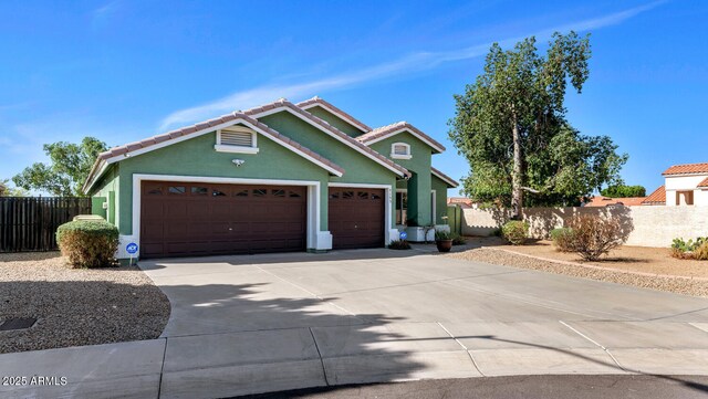 5153 W Topeka Dr, Glendale, AZ 85308 - view of front facade featuring a garage, a tile roof, fence, stucco siding, and driveway