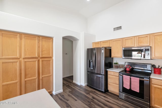 5153 W Topeka Dr, Glendale, AZ 85308 - kitchen featuring high vaulted ceiling, light countertops, visible vents, stainless steel appliances, and arched walkways