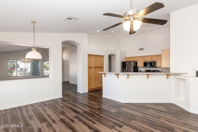 5153 W Topeka Dr, Glendale, AZ 85308 - kitchen featuring visible vents, arched walkways, dark wood-style flooring, appliances with stainless steel finishes, and a peninsula