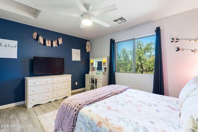 bedroom with attic access, visible vents, baseboards, a ceiling fan, and wood tiled floor