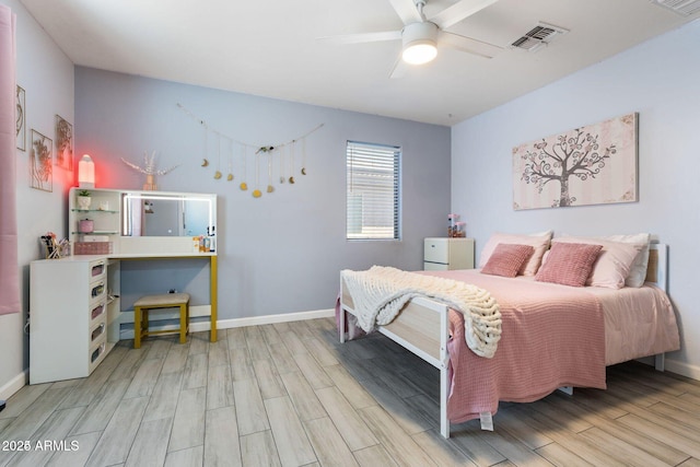 bedroom featuring baseboards, ceiling fan, visible vents, and wood tiled floor