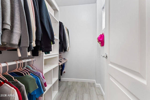 spacious closet with wood finish floors