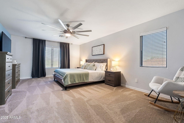 bedroom with light carpet, ceiling fan, visible vents, and baseboards