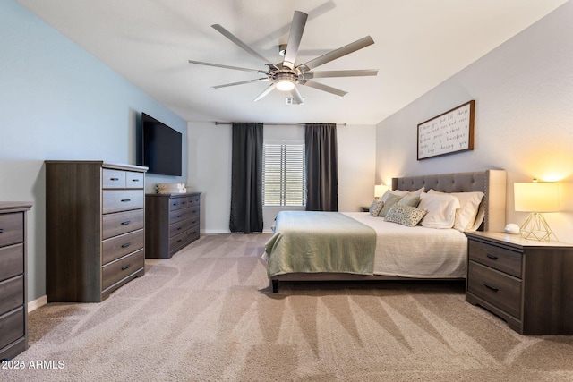 bedroom featuring light carpet, ceiling fan, and baseboards