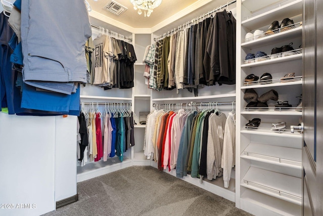 walk in closet featuring a chandelier, carpet, and visible vents