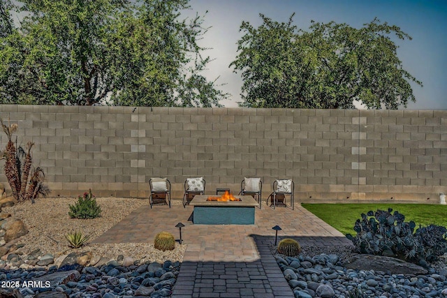 view of patio / terrace featuring an outdoor fire pit and fence