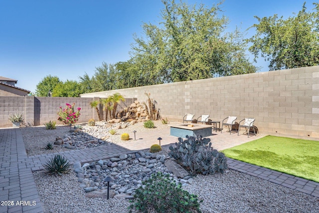 view of yard with a patio area and a fenced backyard