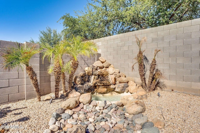 exterior details featuring a fenced backyard