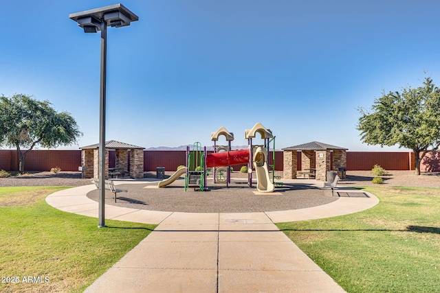 communal playground with a yard, fence, and a gazebo