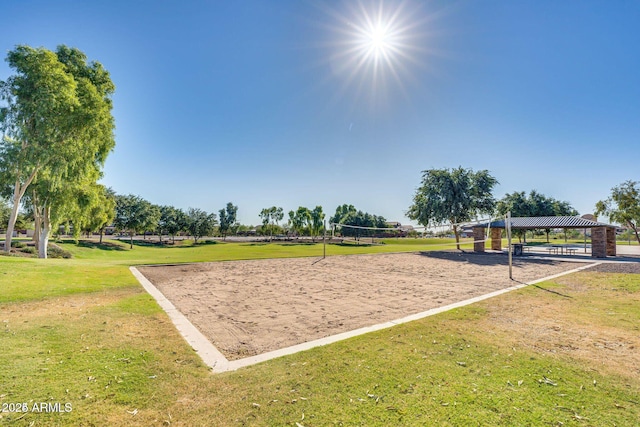 view of property's community featuring volleyball court and a lawn