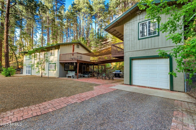 8475 S Breezy Pine Rd, Mayer, AZ 86333 - view of front facade with an attached garage, a deck, a patio, and driveway