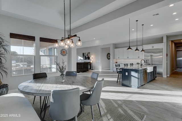 dining area featuring sink and light wood-type flooring