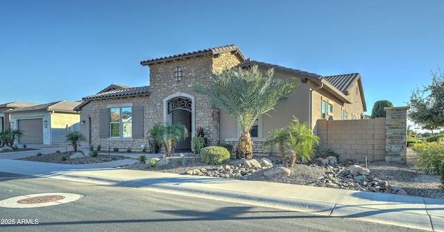 mediterranean / spanish house with a garage