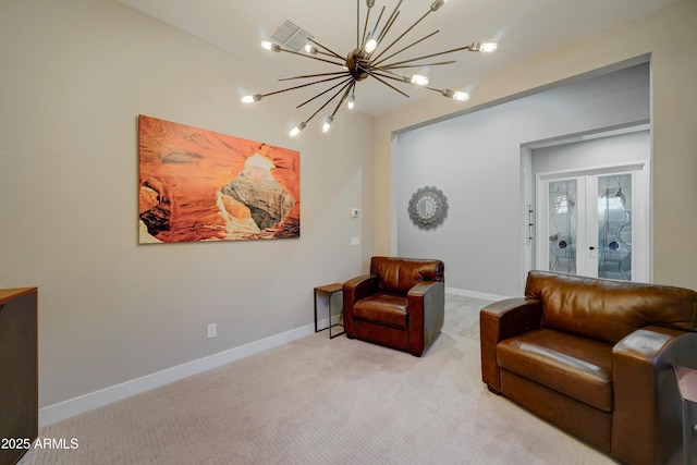 living area with light colored carpet, a notable chandelier, and french doors