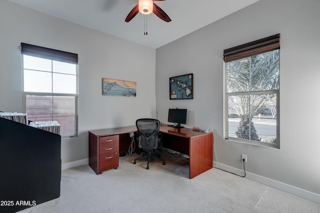 office area featuring light carpet and ceiling fan