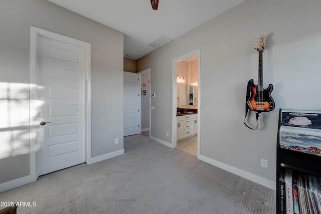 carpeted bedroom featuring connected bathroom