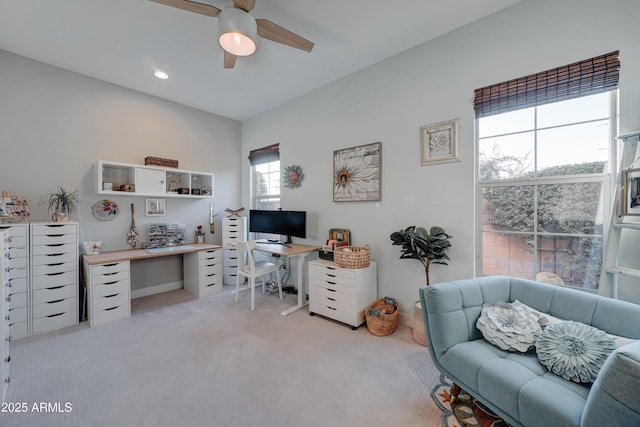 carpeted home office with ceiling fan