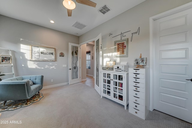 sitting room featuring ceiling fan and light carpet