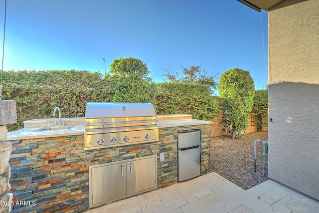 view of patio featuring area for grilling, a grill, and sink