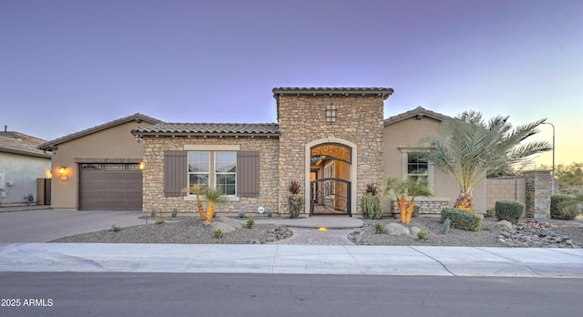 mediterranean / spanish house with a garage