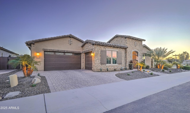 mediterranean / spanish-style home with a garage