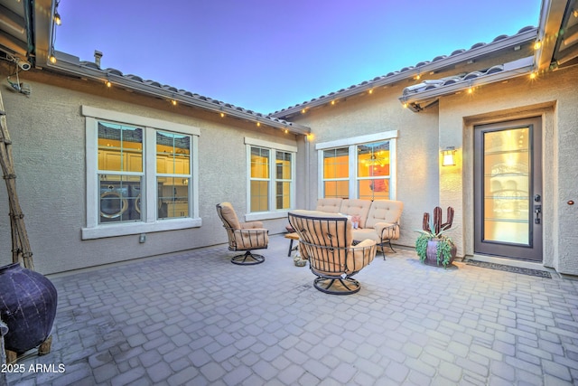 patio terrace at dusk featuring outdoor lounge area